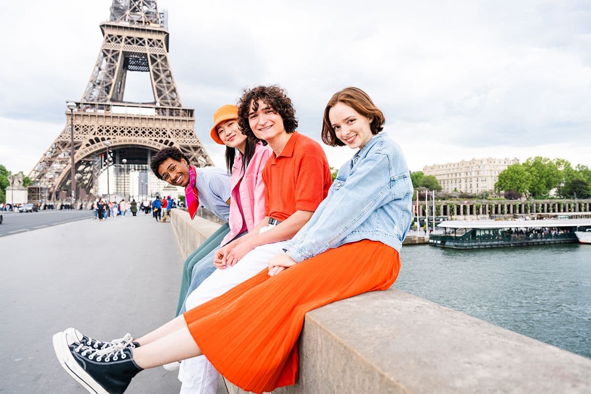 Group of young students visiting Paris and Eiffel Tower
